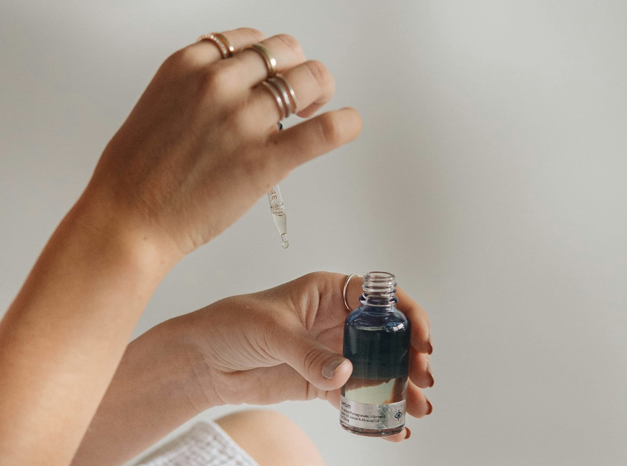 person holding black glass bottle