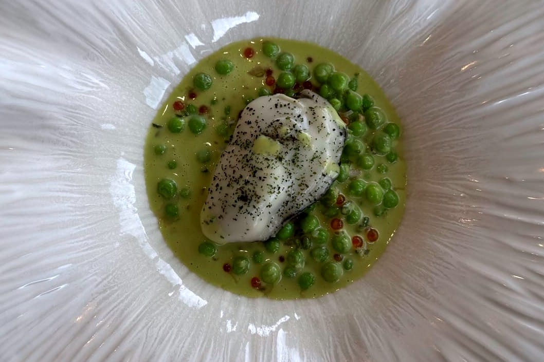 Oyster No. 3 with green pea, lovage, and champagne