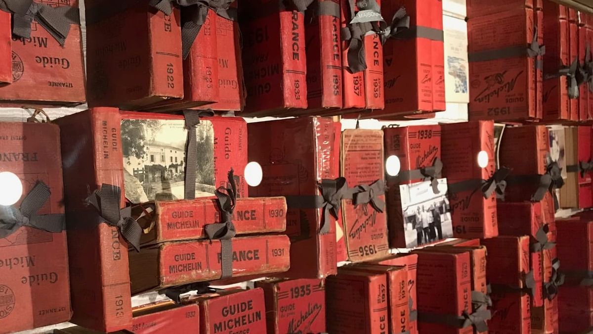 Vintage Michelin Guides from the early 20th century displayed on shelves — the historical origins of the world’s most influential restaurant rating system.