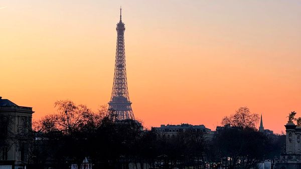 Eiffel Tower at sunset in soft pastel light, Paris skyline.