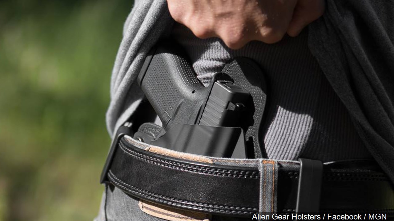A man with a gun in his belt