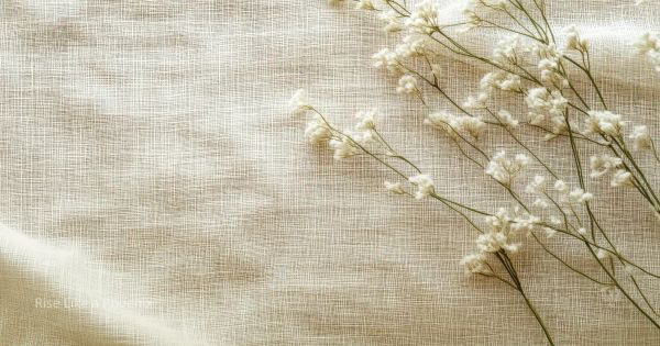 Soft linen fabric with delicate white flowers in natural light, evoking quiet awareness and gentle attention.