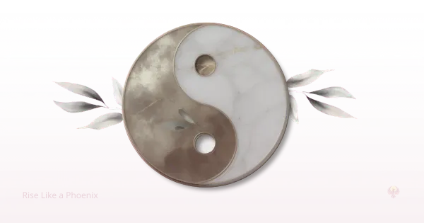 A yin-yang symbol in gold and white tones, representing balance and symbolic meaning during emotional and spiritual awakening.