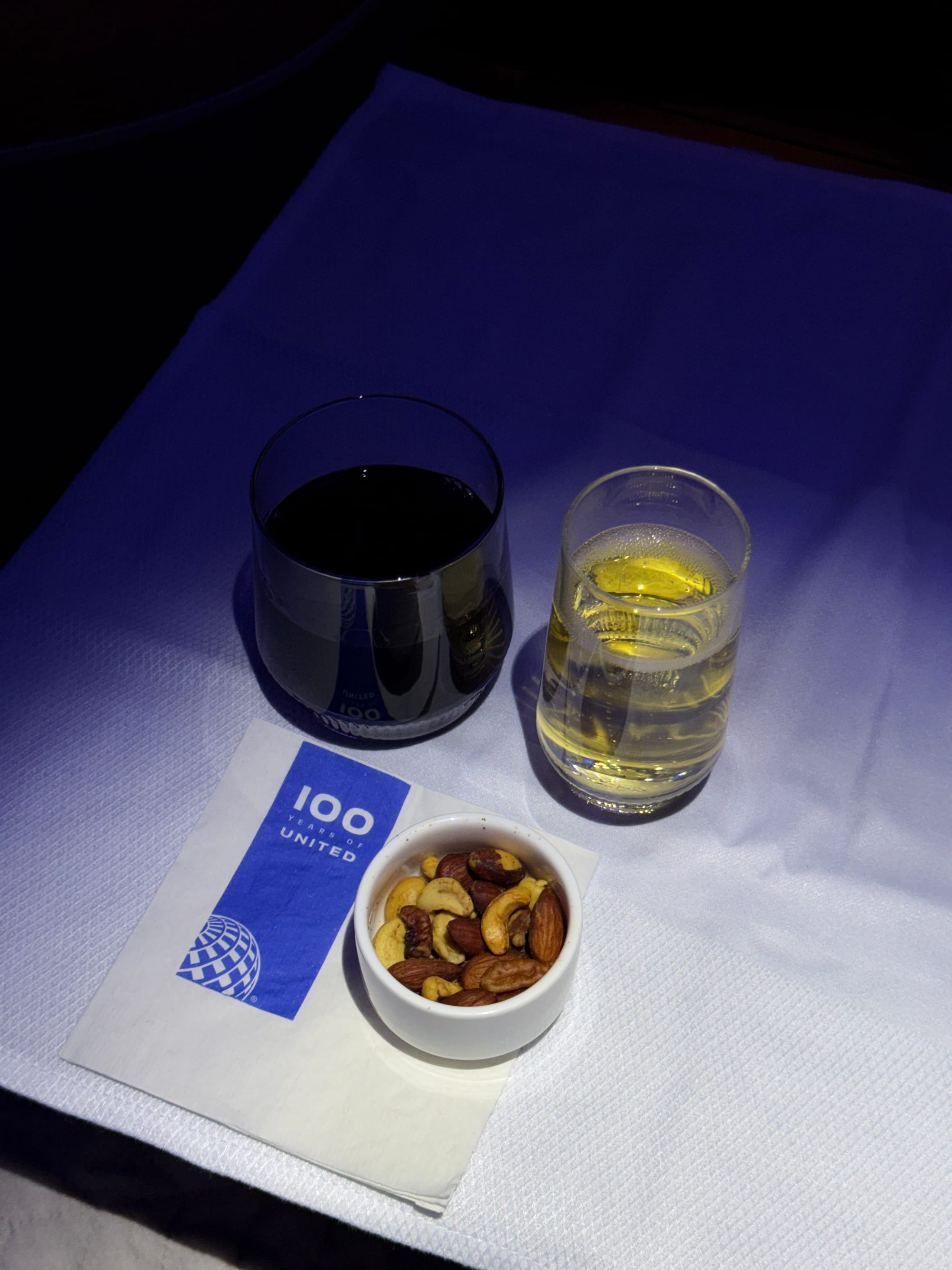 Red wine and water with United 100 coaster on UA1