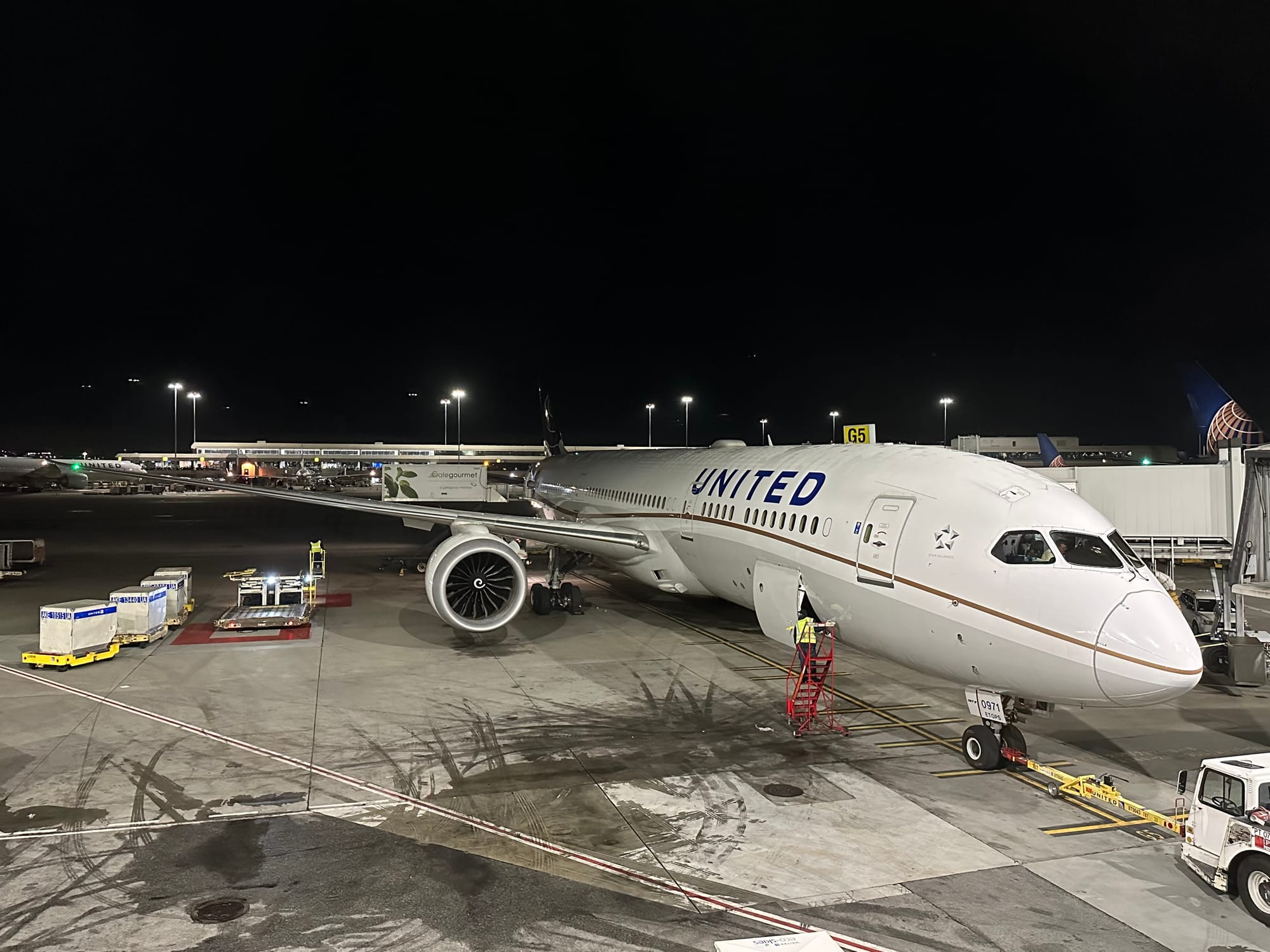 United 787-9 at the SFO gate at night in 2023