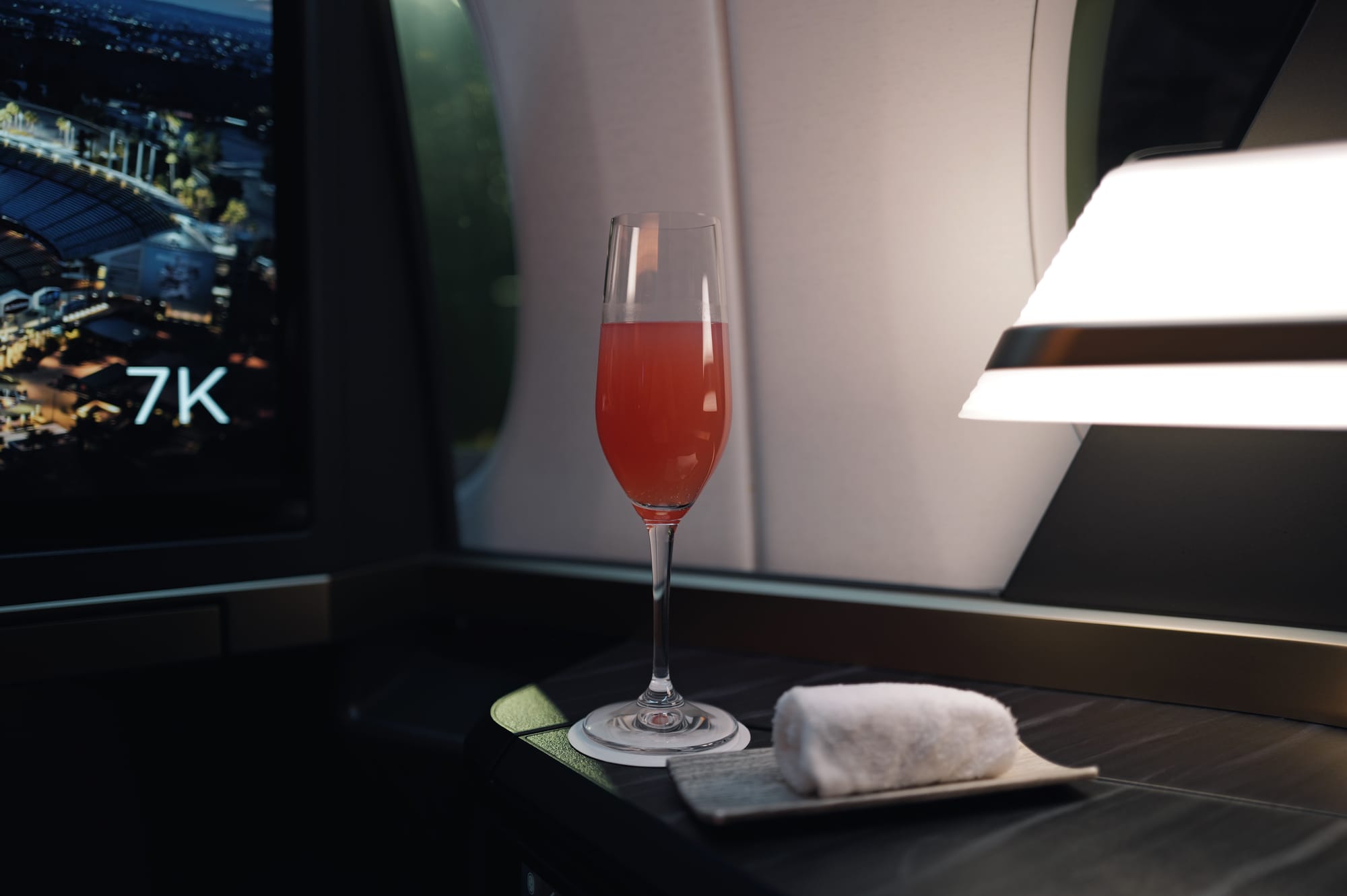 Glass of water at the STARLUX A350 business class window seat before departure from LAX