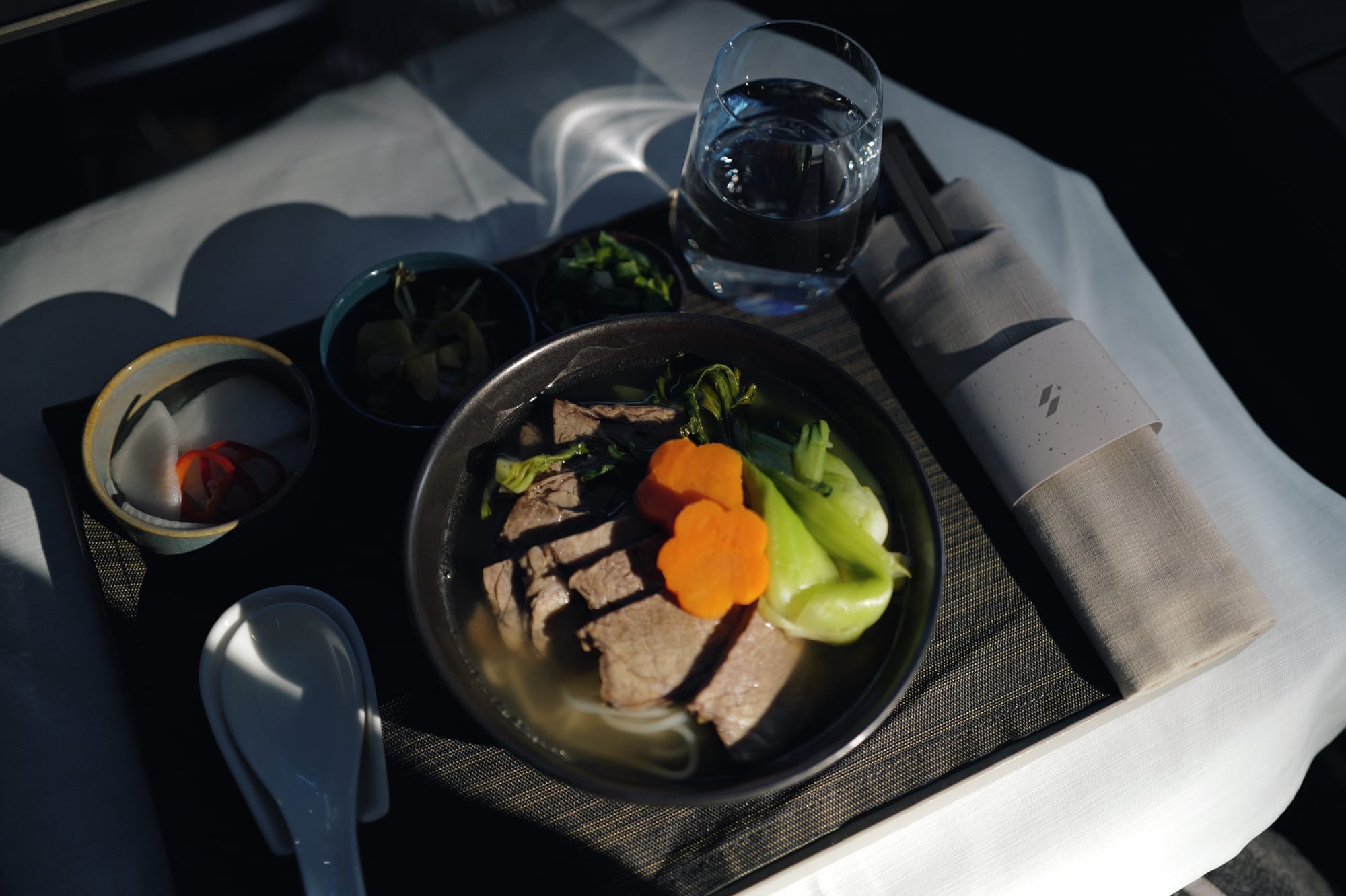 STARLUX business class beef noodle soup with pickled radish on flight JX1