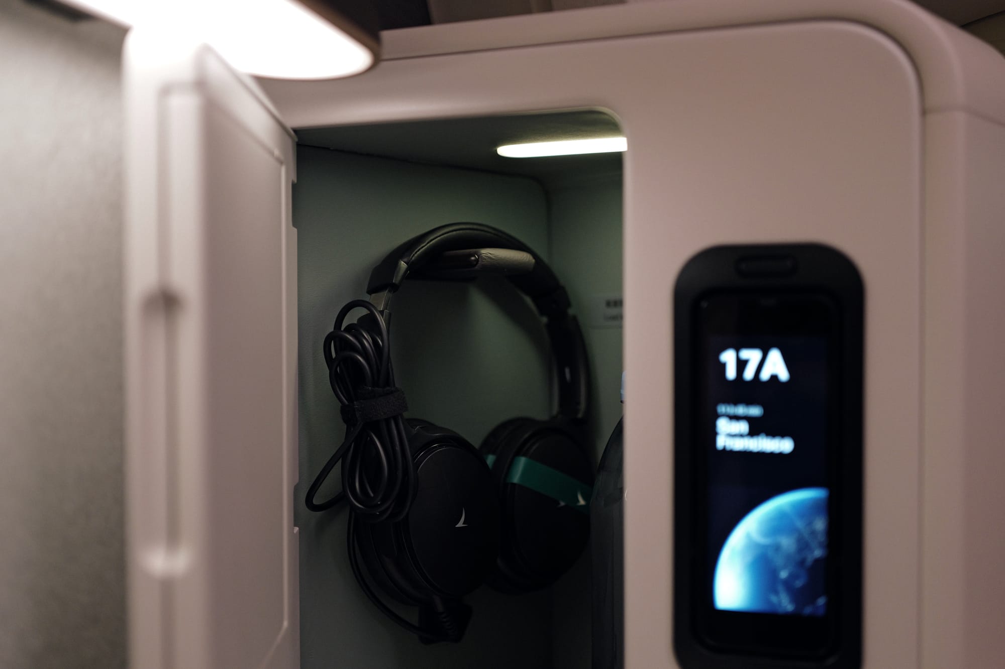 Custom headphones stowed beside the Aria Suite side screen