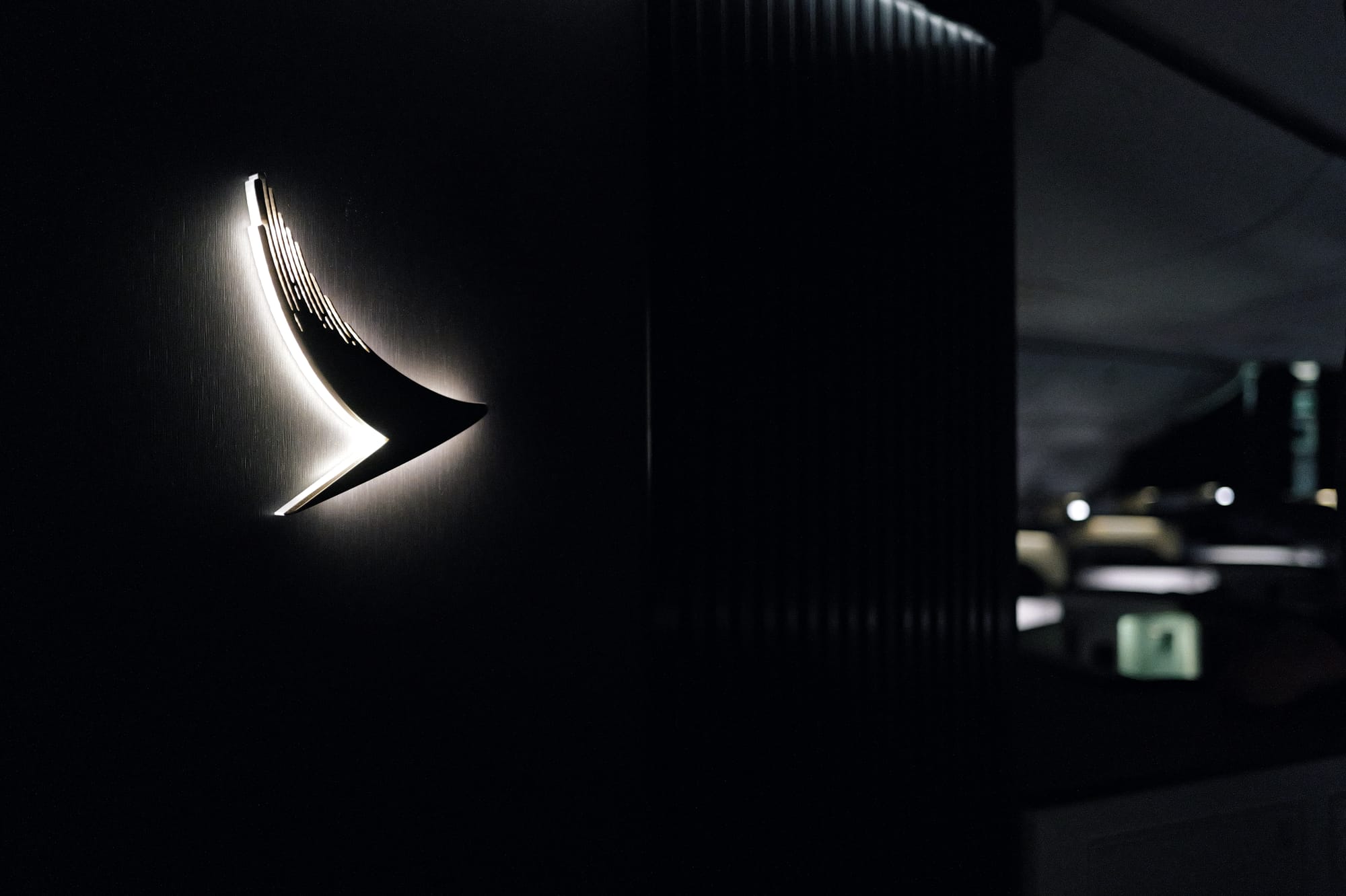 Brushwing wall light lit like a gallery piece