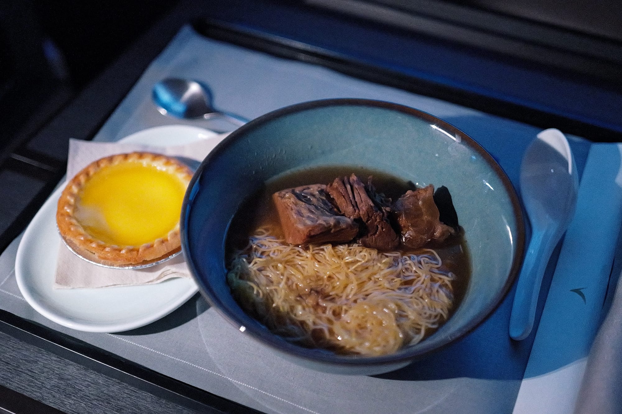 Beef brisket noodles and egg tart from the Aria Suite anytime menu