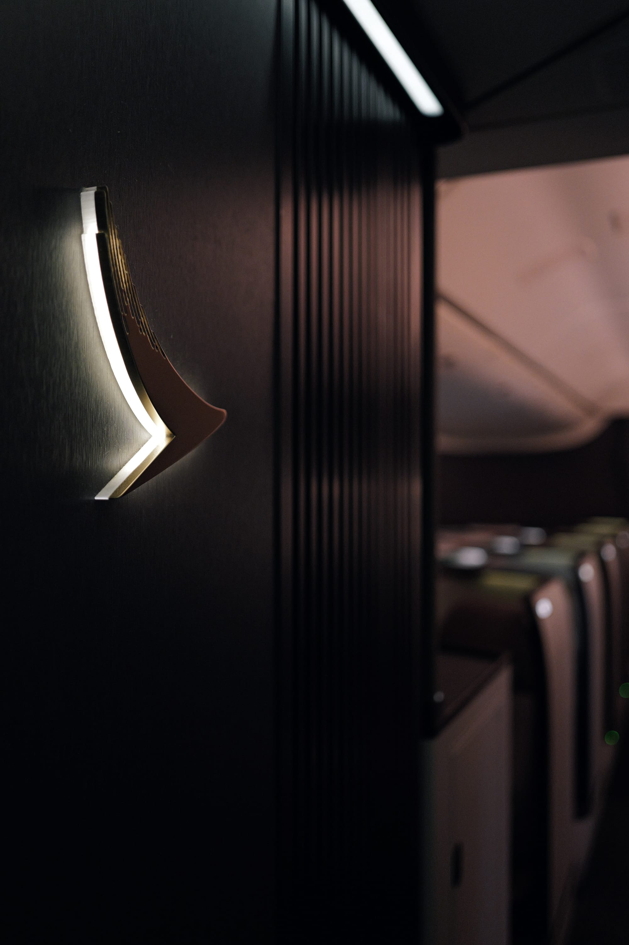 Backlit brushwing wall light in the Cathay Pacific Aria Suite cabin