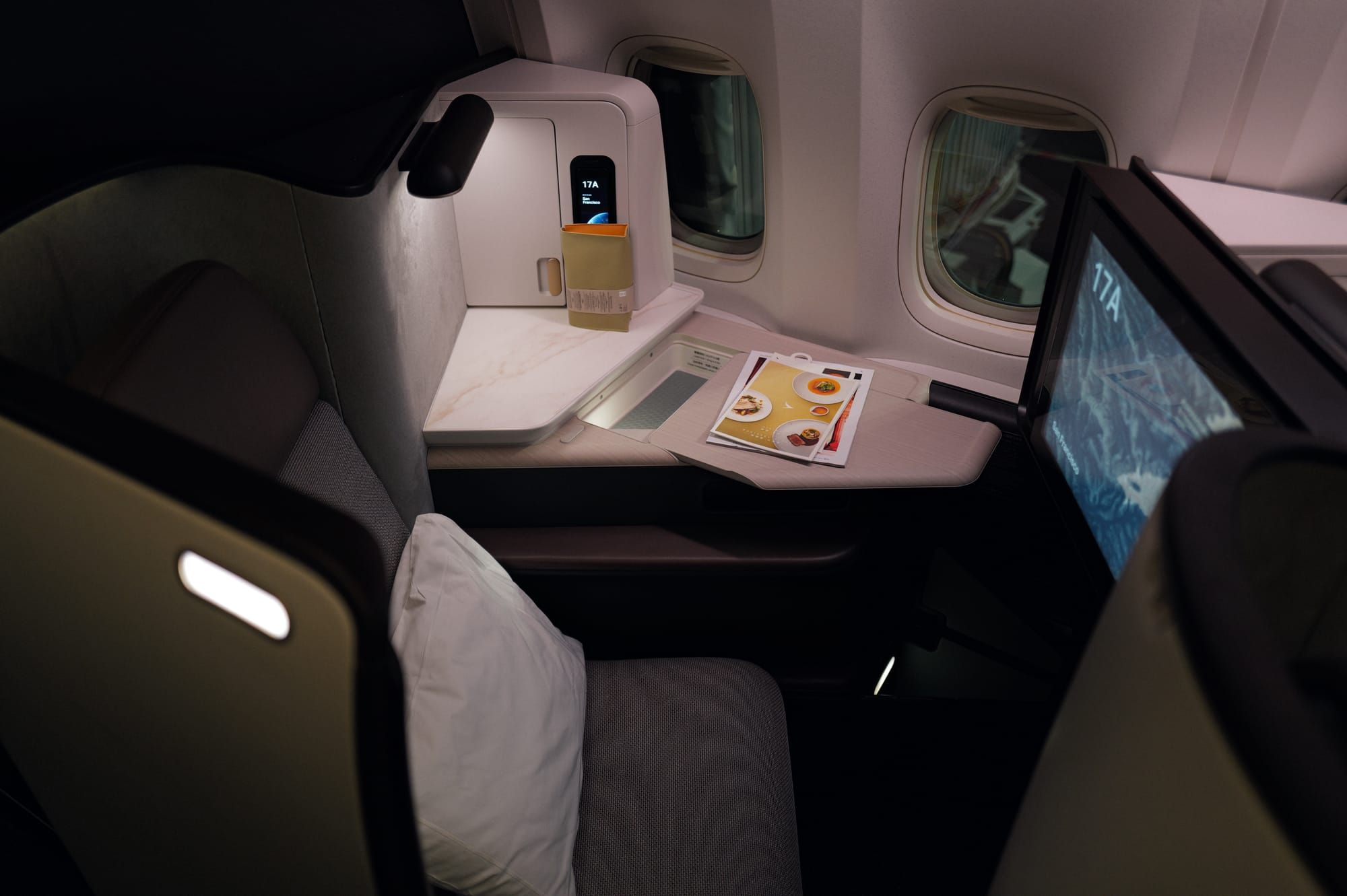 Cathay Pacific Aria Suite seat 17A at boarding with welcome drink, 777-300ER