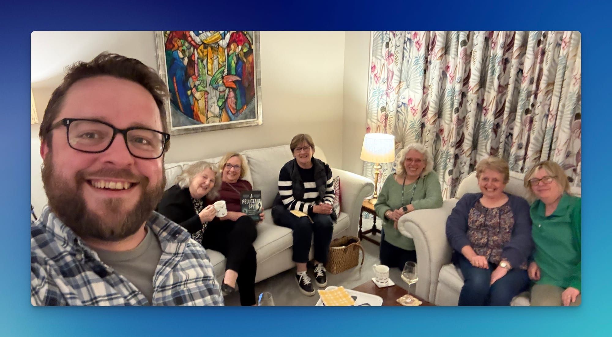 A selfie of me and the members of the 'Three W's Book Club', sitting on sofas in a white room
