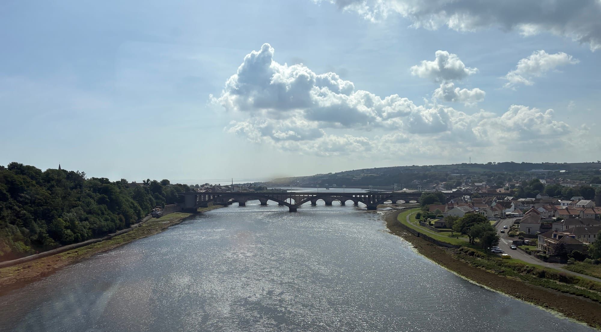 A view of a bridge, river and clouds from the southbound train to York