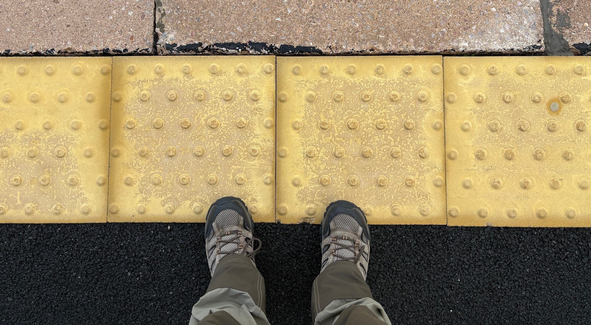 My shoes on a train platform edge