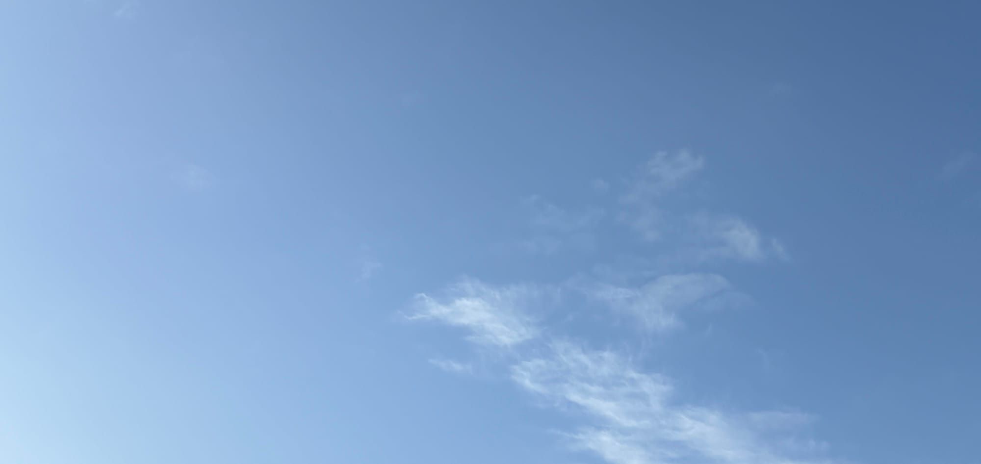 A blue sky with light clouds