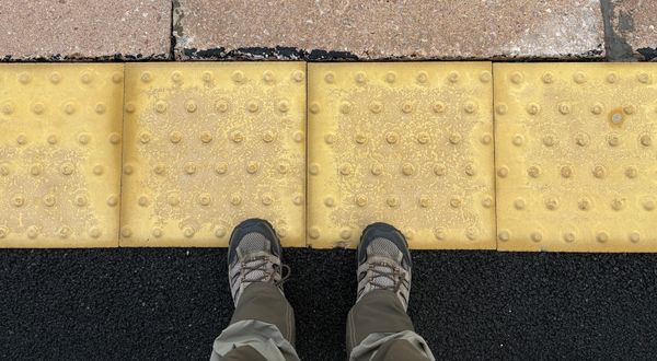 My shoes on a train platform edge