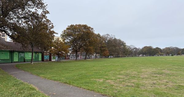 Leith Links, with trees and open grass and a path leading to buildings