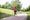 A woman runs at a very slow pace in the park