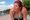 A plus-size woman after a run, with a flushed, beet-red sweaty face
