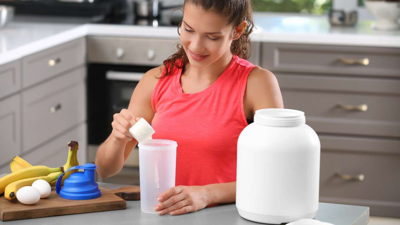 Woman gets her daily protein by mixing 1 serving size of collagen supplementation in powder form with other protein sources.