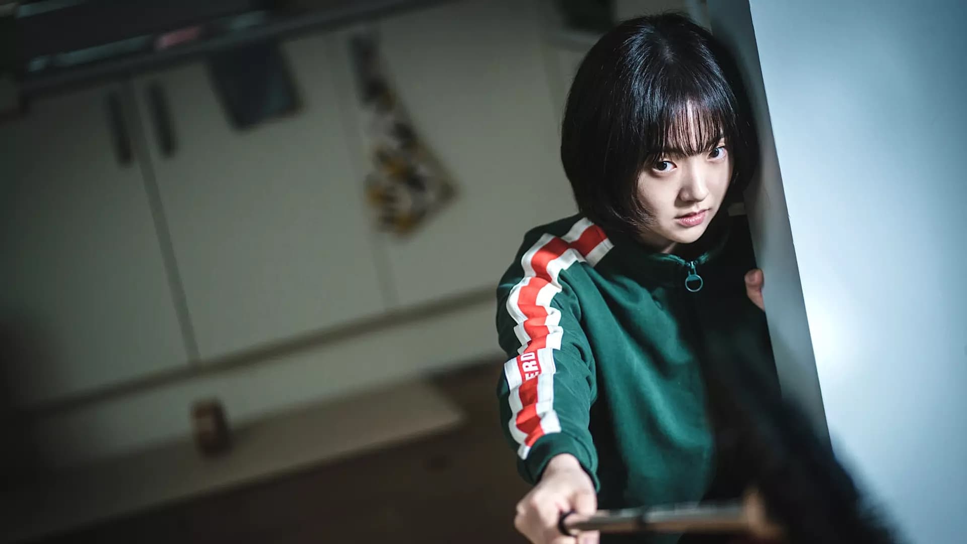 Jeong Jian holds a mirror on a broom stick to spot a sniper in A Shop for Killers. Image courtesy Disney+