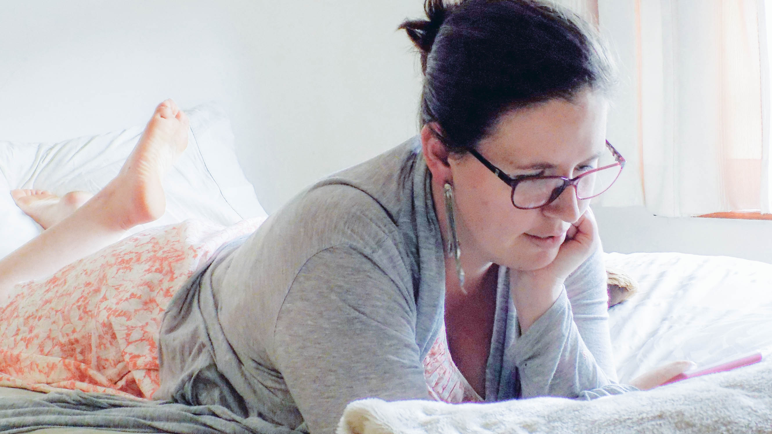 Kelly working in bed