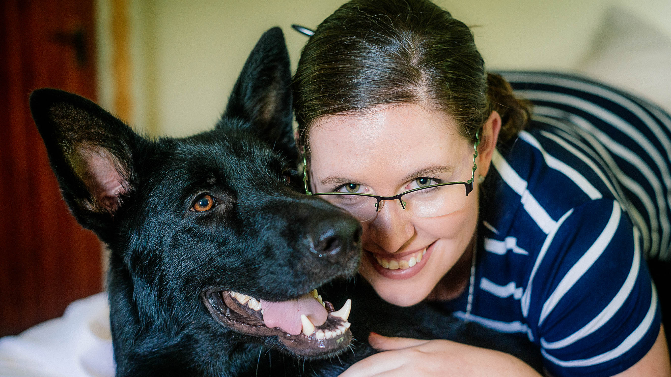Kelly smiling with her dog, Teddy