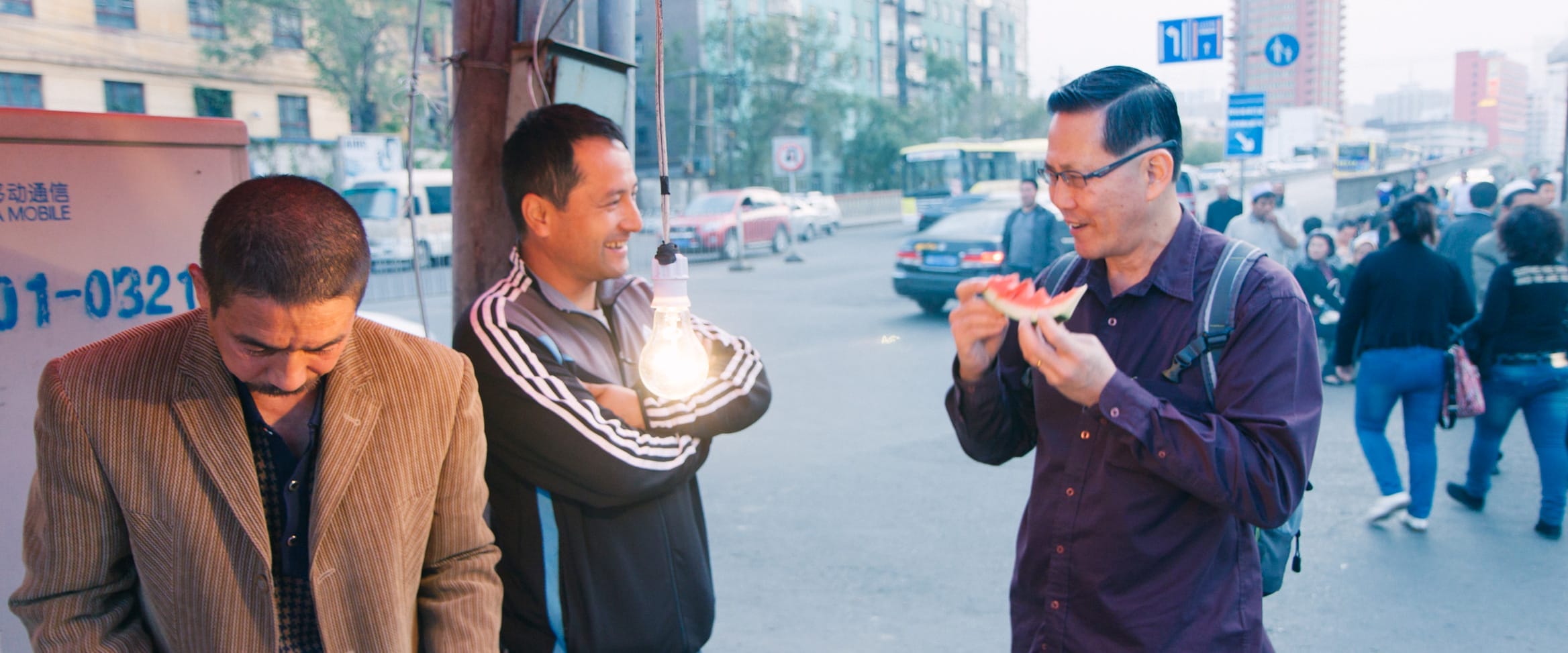 Dad enjoying a watermelon (ironically from Hainan island in the south) at Kashgar, Xinjiang, China.
