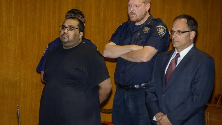 Shane Jaggarnauth standing in a Queens courtroom beside a court officer and his attorney.