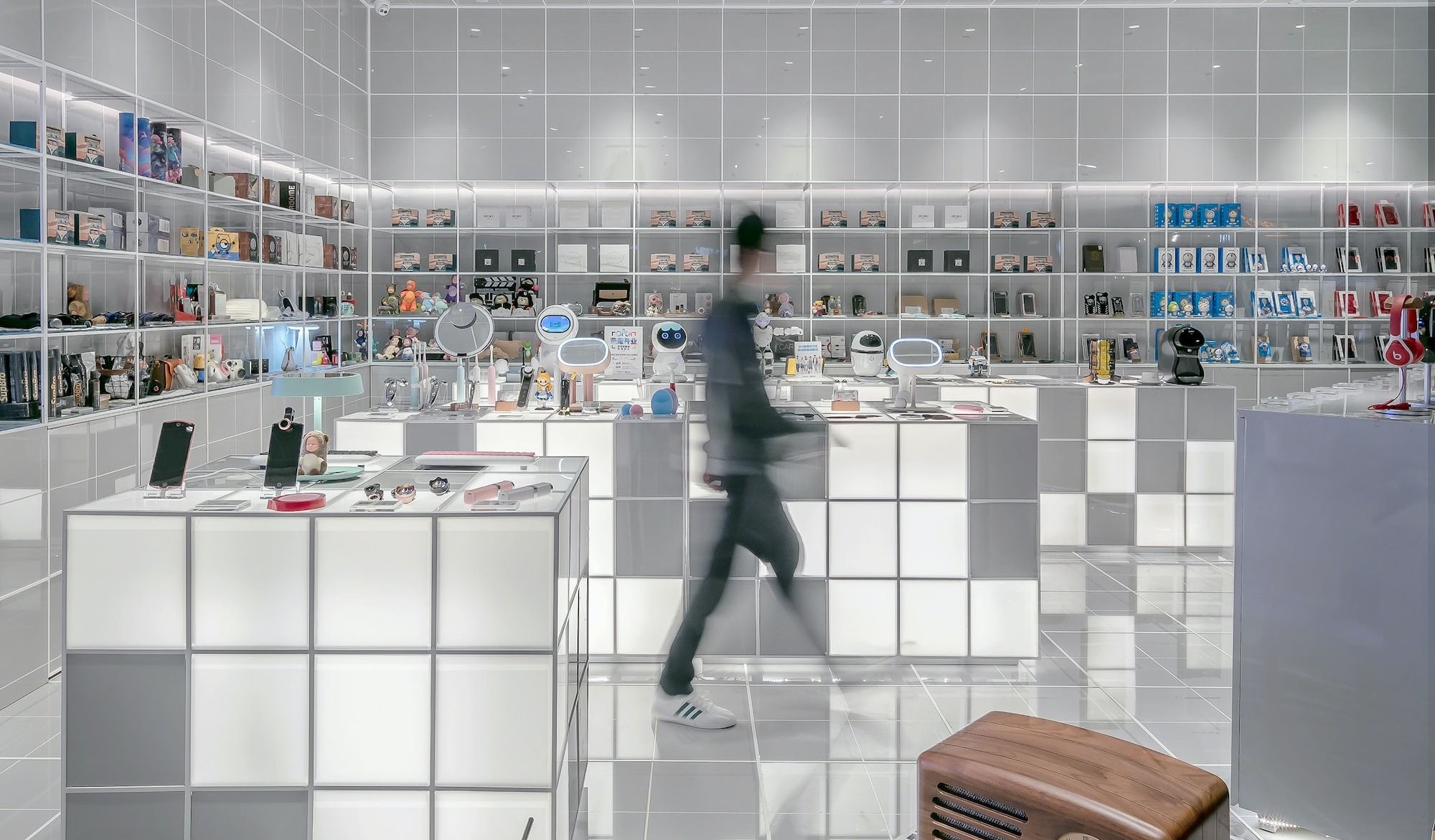 man walking beside white cube decoration