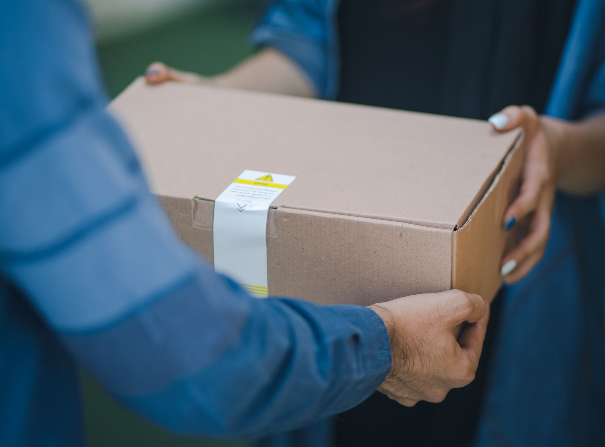 person giving brown box