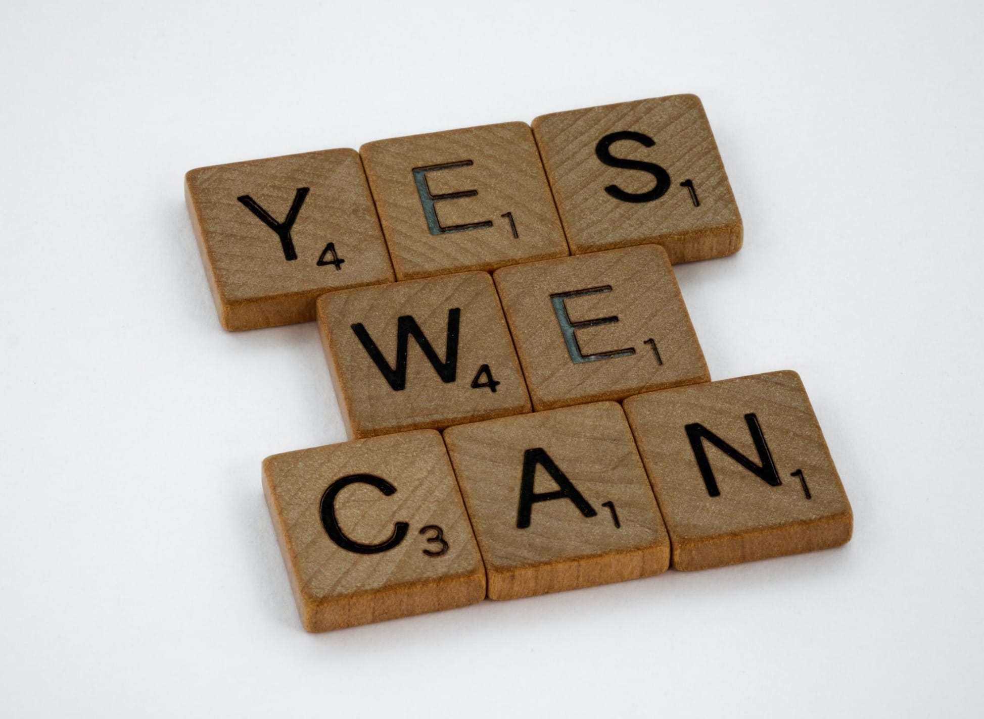 brown wooden letter blocks on white surface