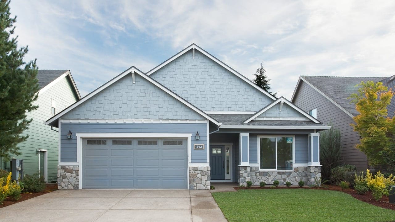 A blue house with a rock foundation