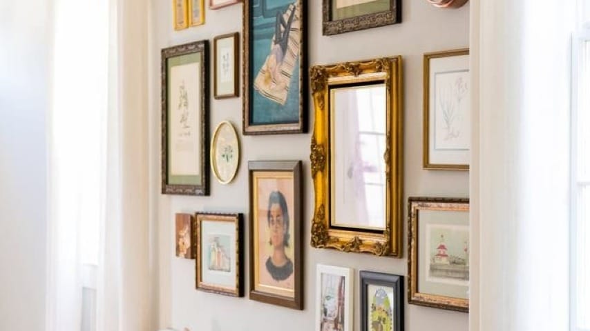 A bunch of different picture frames on a wall