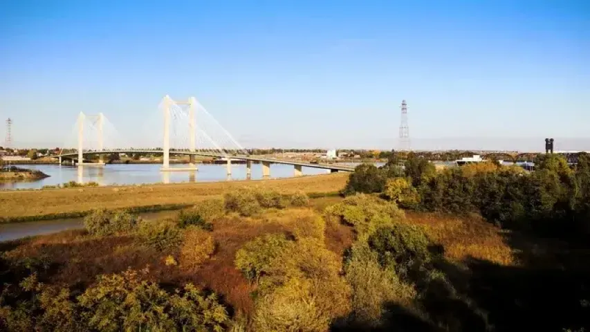A river with a white bridge going over it