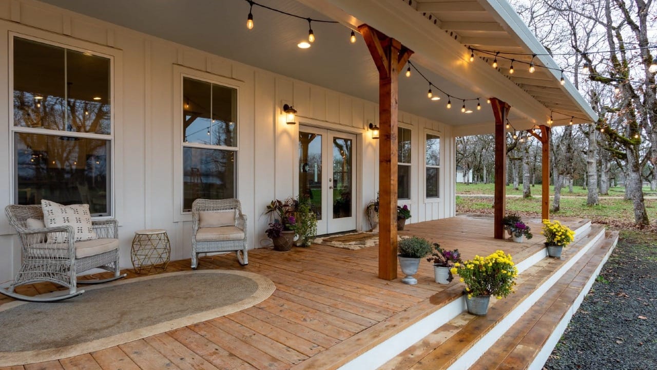 A porch with lights hanging from the ceiling