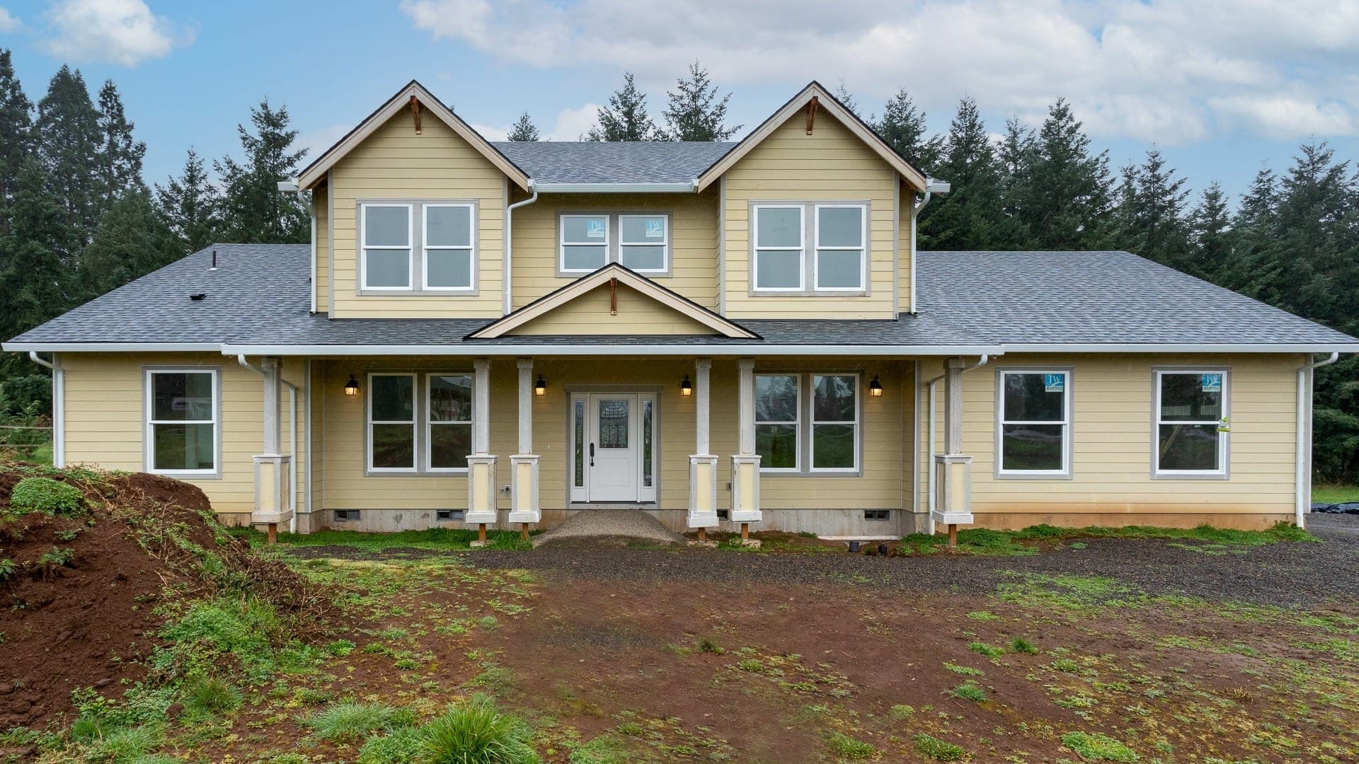 A yellow house in front of a plot of land