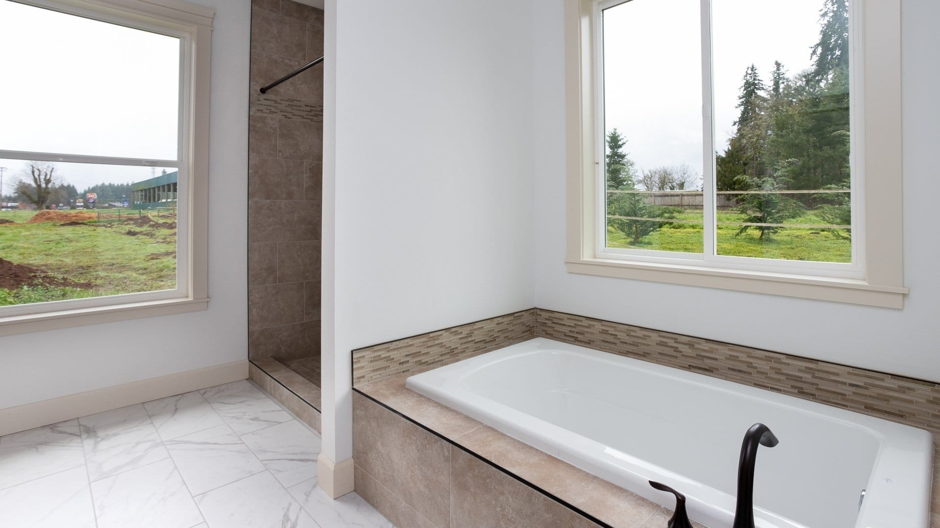 The bathroom with a shower and tub