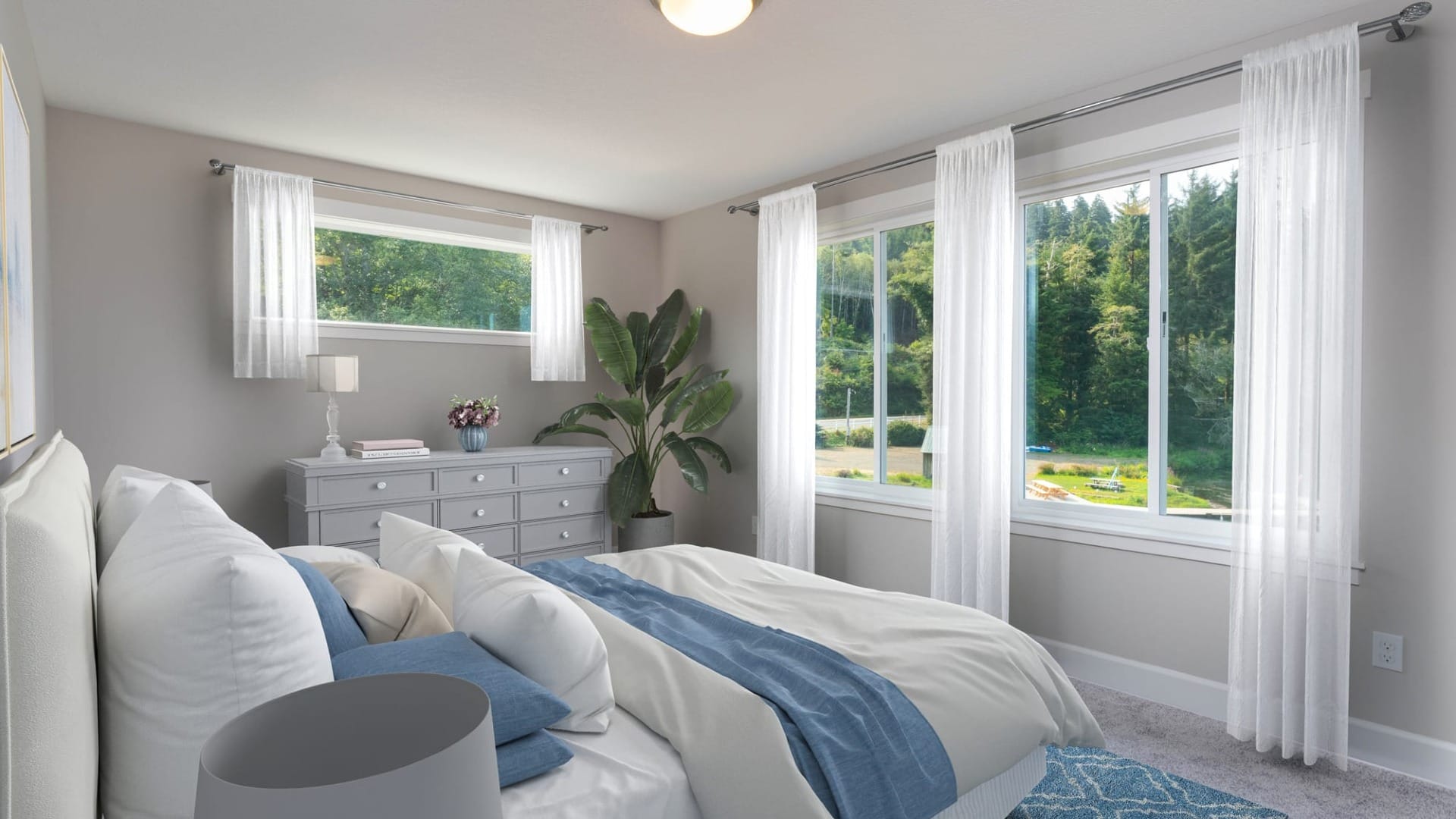 A bedroom with a bed facing a couple windows