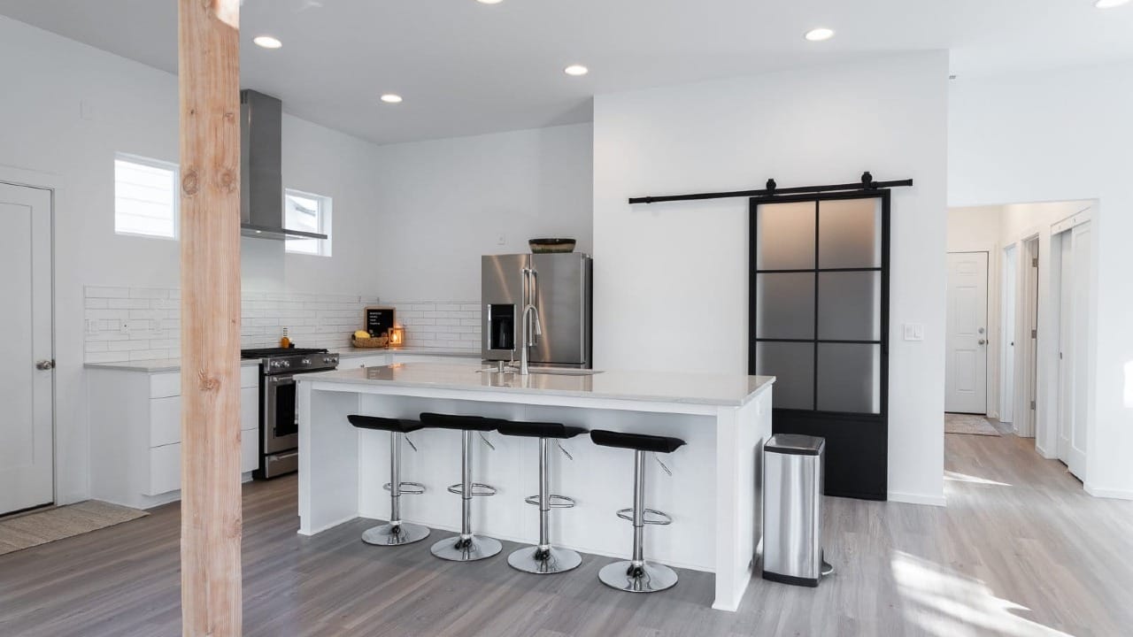 A kitchen with bar stools