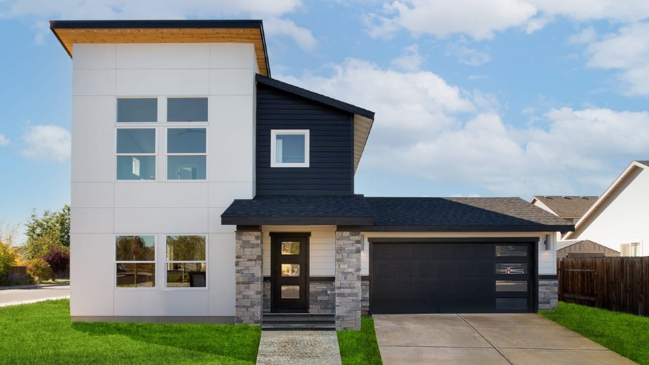 A two-story house that is black and white