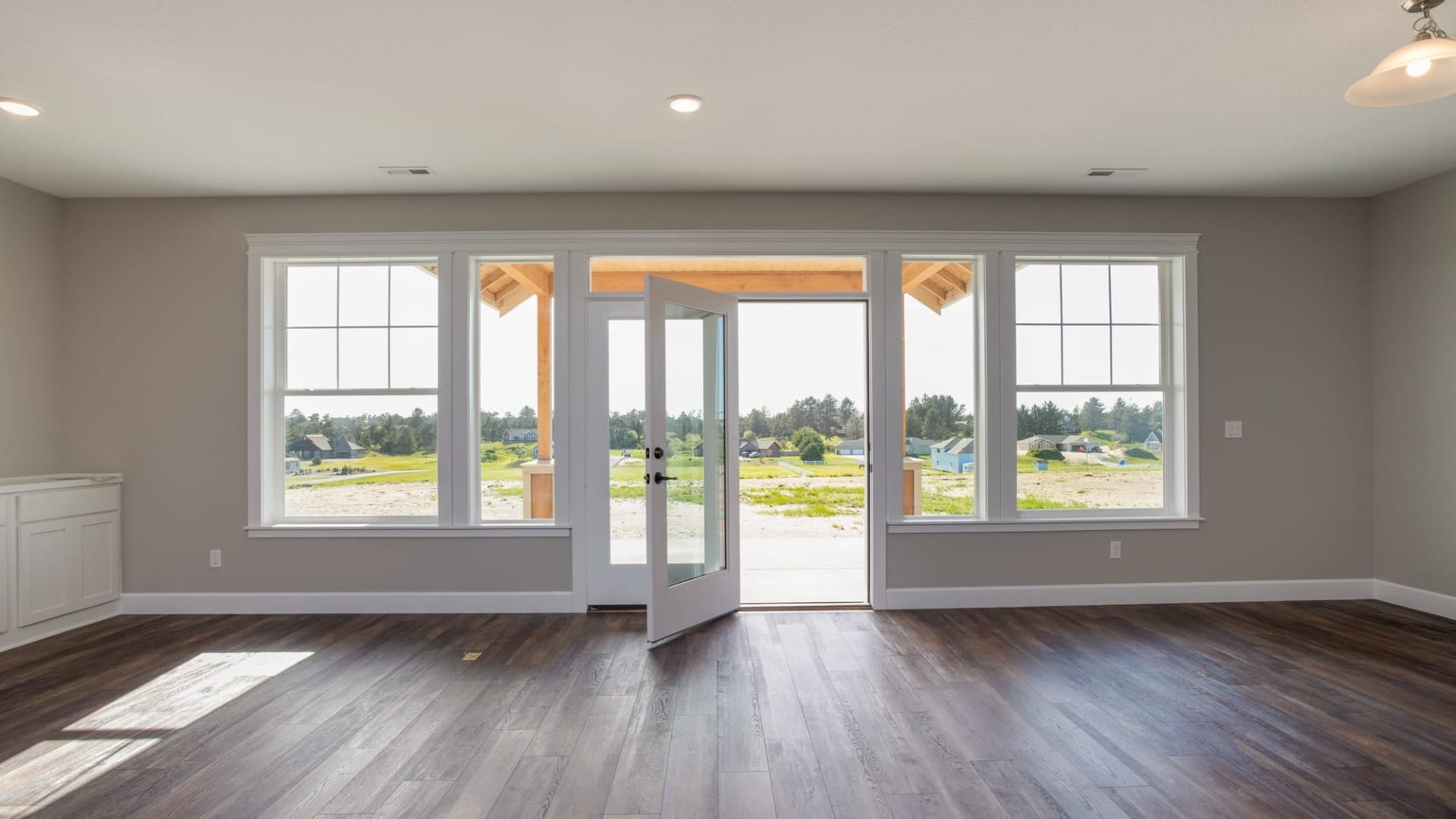 An empty room with a door that is wide open