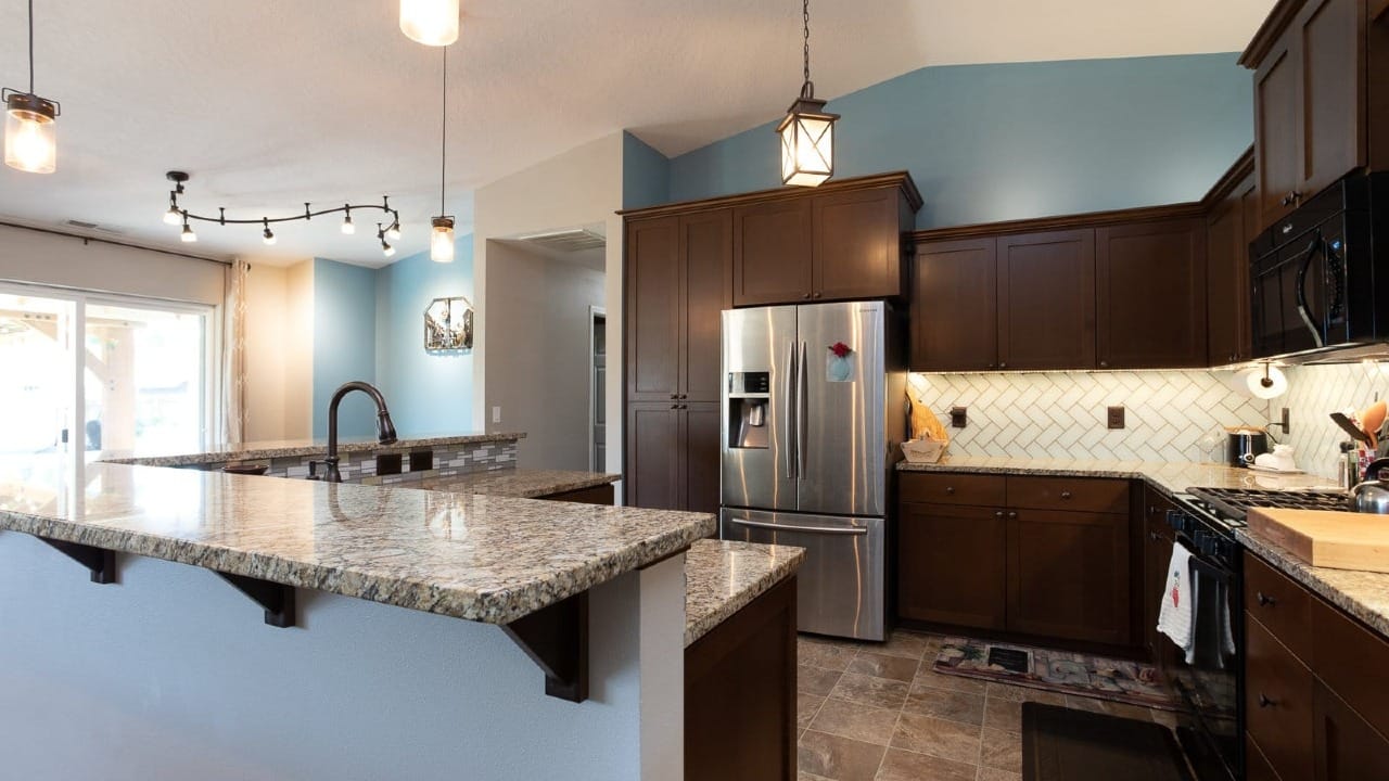 A kitchen with dark wood cabinets
