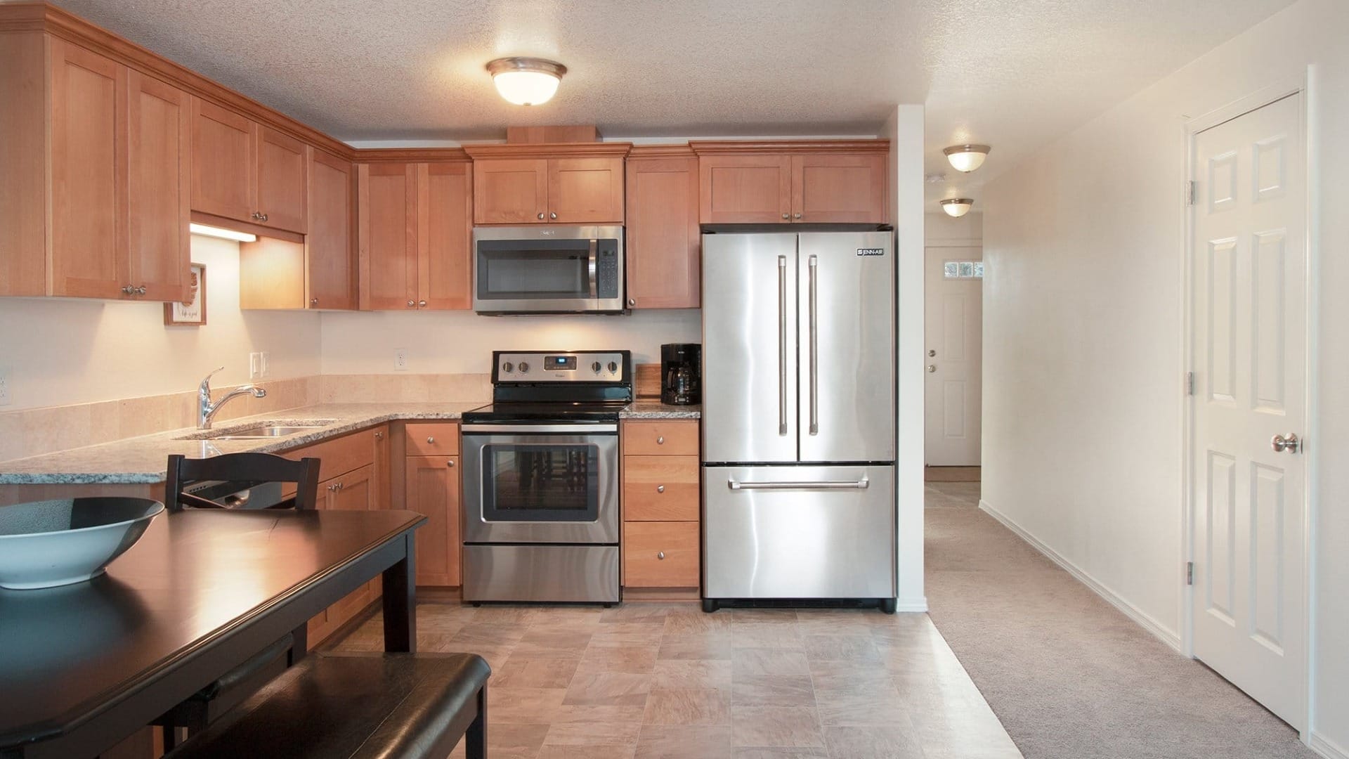 A kitchen with wooden cabinets