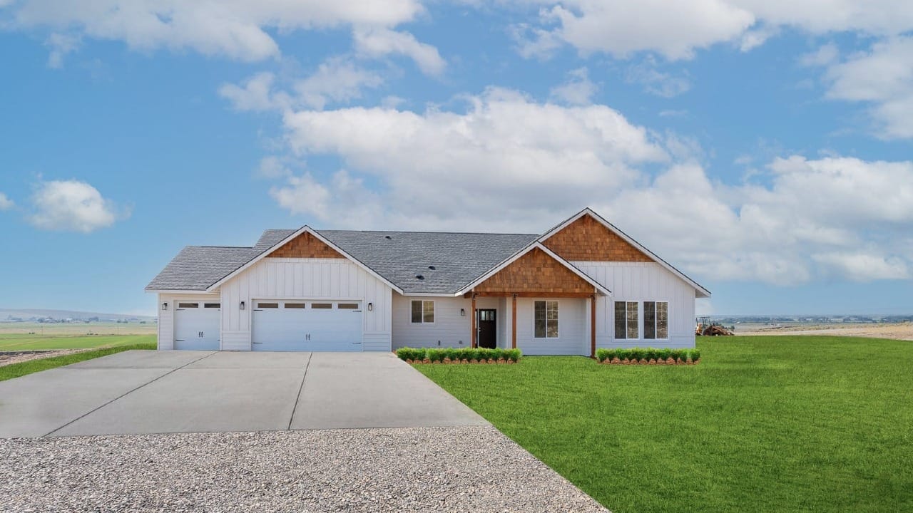 A house with white siding inderneath a blue sky