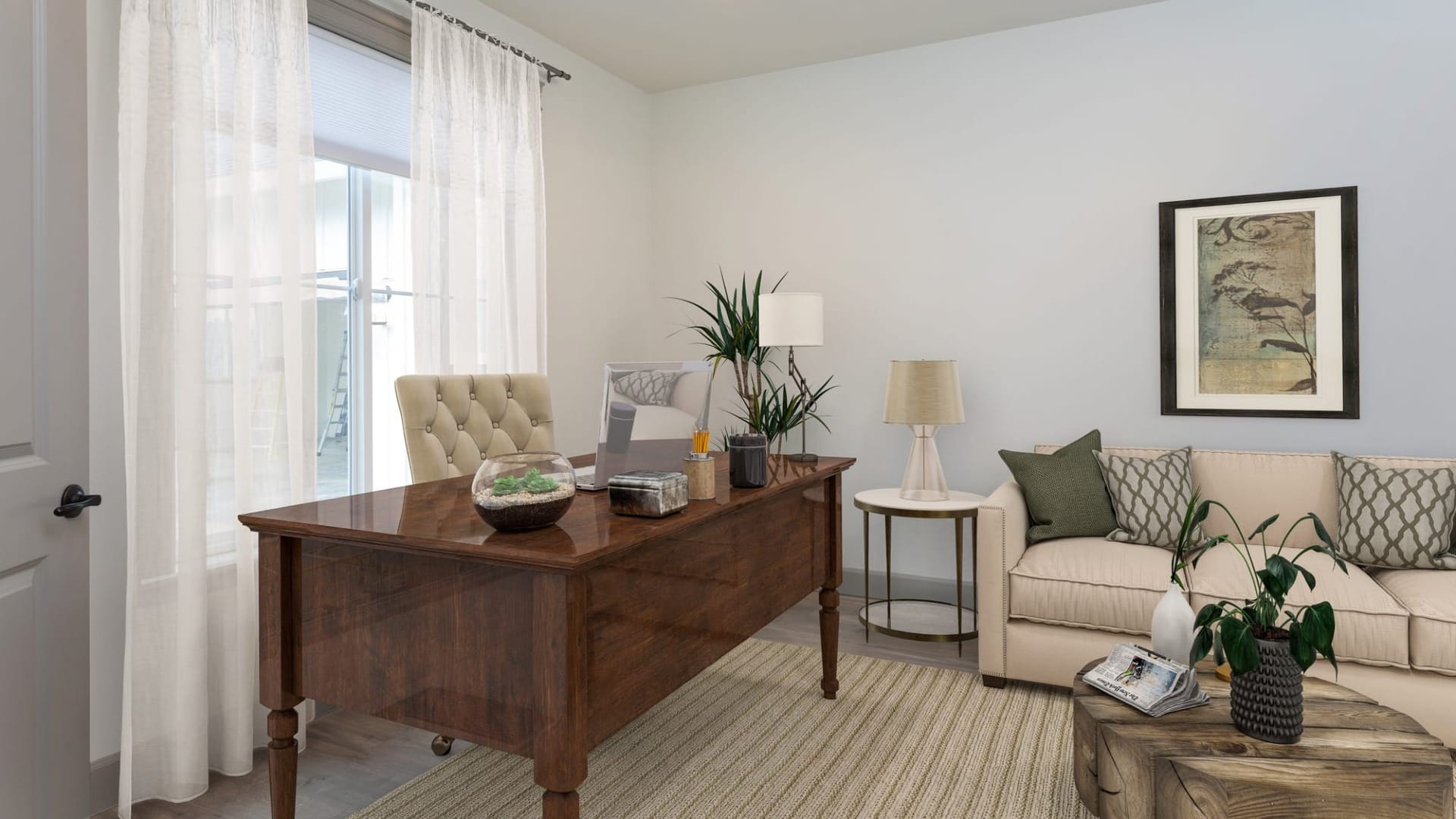 A living room with a desk and chair inside a custom home