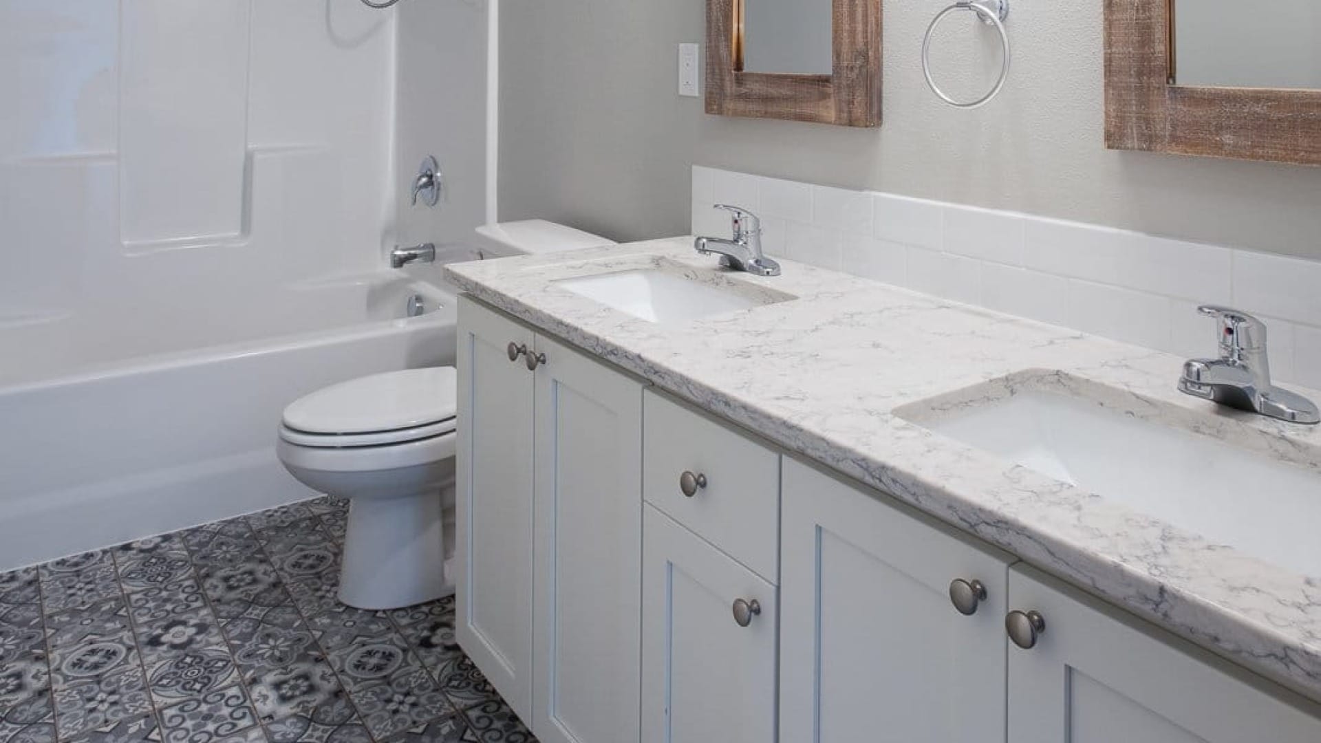 A bathroom with multiple sinks in it in the olympus plan
