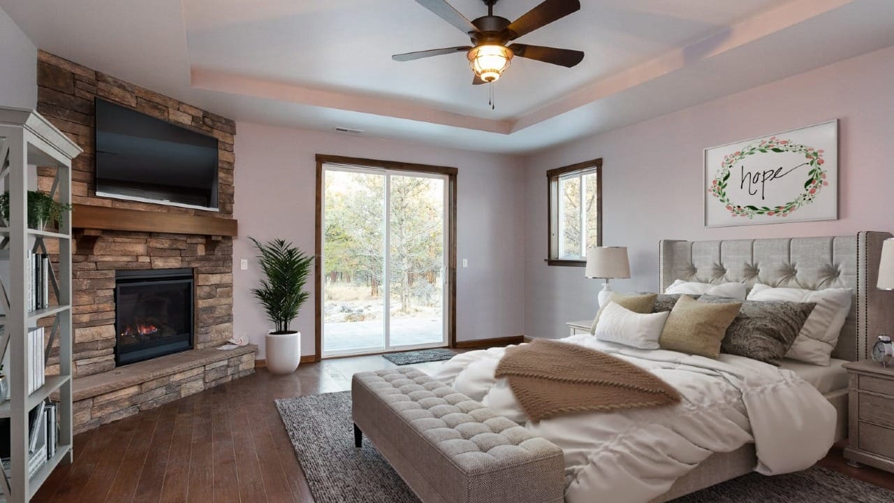 Master bedroom with a fireplace in the olympus plan
