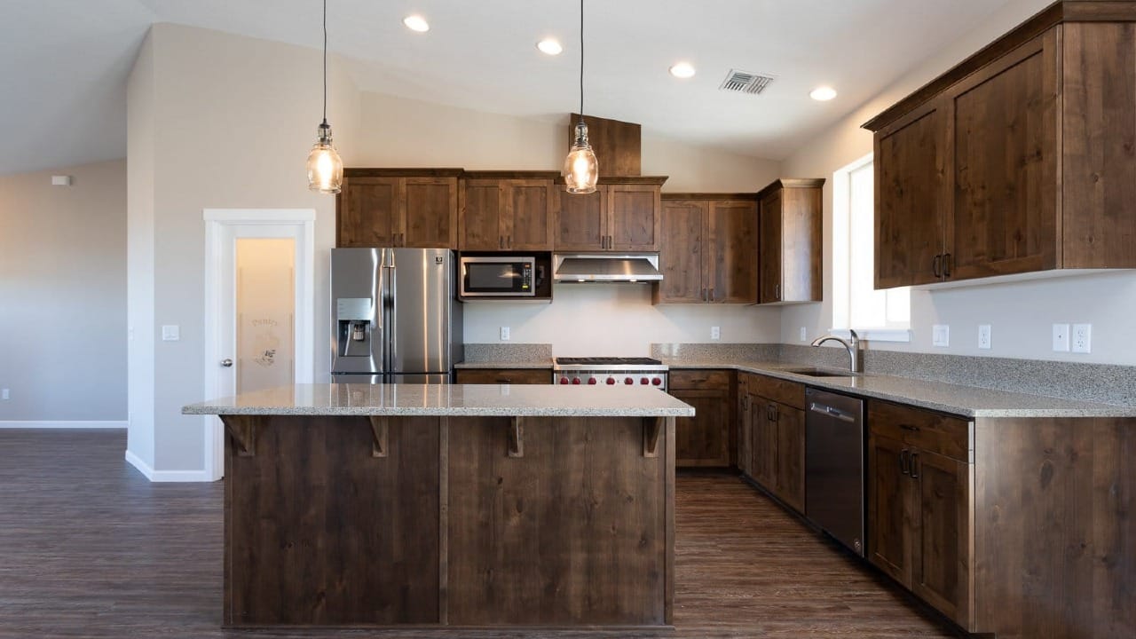 A kitchen with wooden cabinets